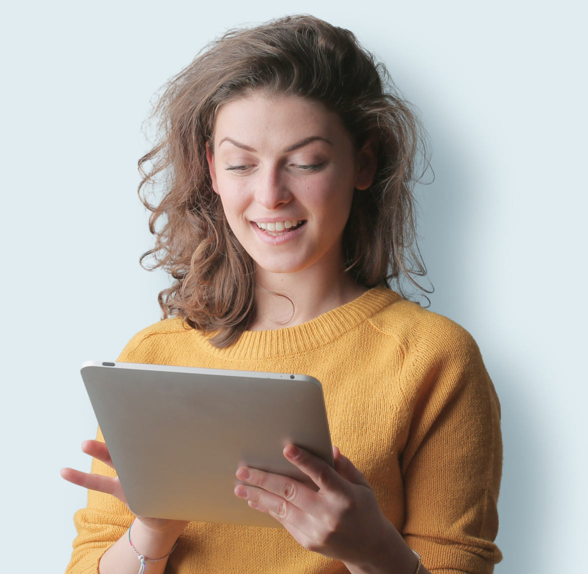 women-homepage Woman holding and looking down at a tablet